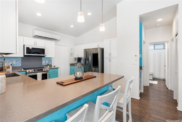 801 Kakala St Unit 50, Kapolei, HI 96707 - kitchen with stainless steel appliances, a wall unit AC, a sink, decorative backsplash, and white cabinets