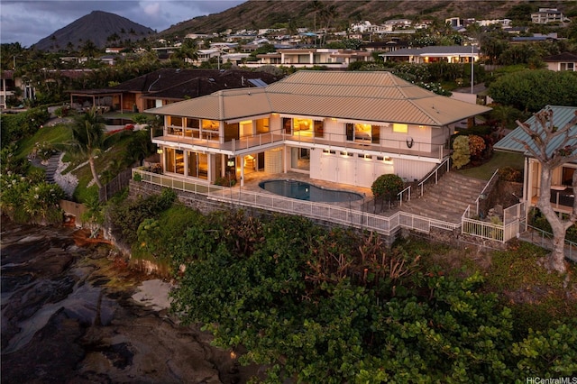 120 Hanapepe Loop, Honolulu, HI 96825 - rear view of property featuring a balcony, a mountain view, a fenced backyard, a hot tub, and a patio area