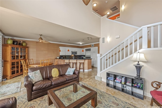 92-1037D Koio Dr Unit M1-4, Kapolei, HI 96707 - living area with ceiling fan, ornamental molding, stairway, a towering ceiling, and baseboards