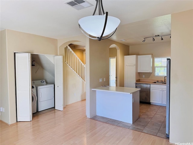 91-1014 Kaipalaoa St Unit 6504, Ewa Beach, HI 96706 - kitchen with dishwasher, arched walkways, white cabinets, light countertops, and light wood-type flooring