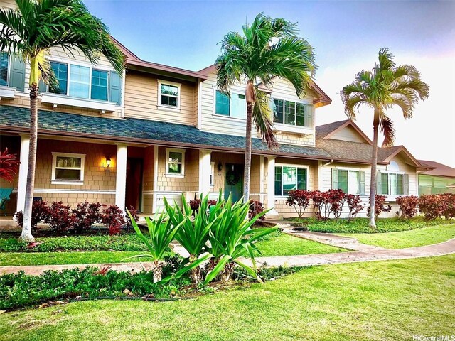 91-1014 Kaipalaoa St Unit 6504, Ewa Beach, HI 96706 - view of front of house featuring a porch, roof with shingles, and a front lawn