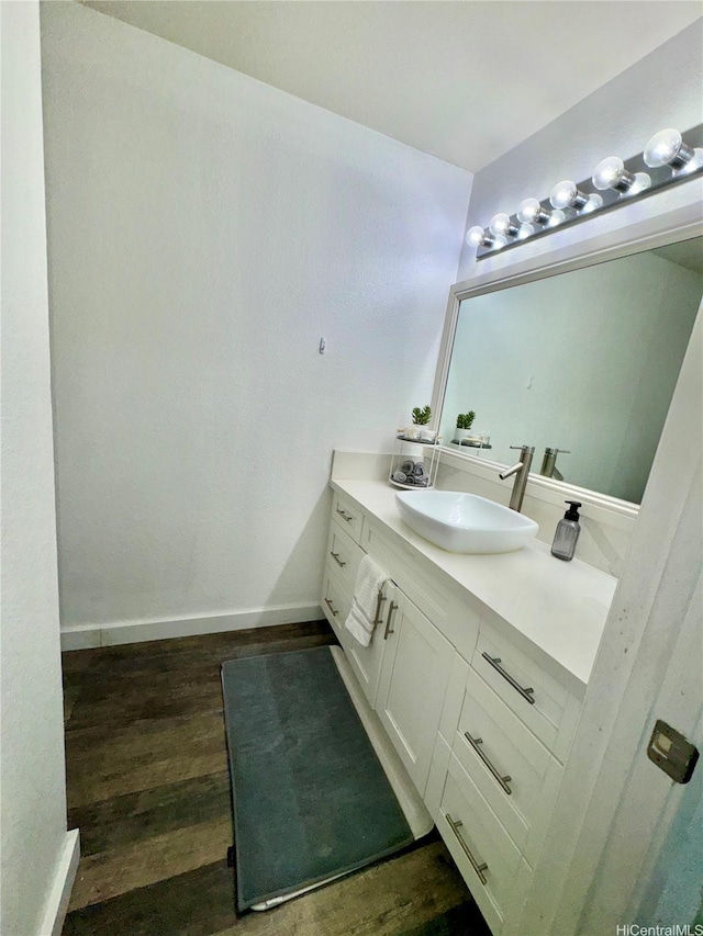 645 Mananai Pl Unit 23Bd, Honolulu, HI 96818 - bathroom featuring vanity, wood finished floors, and baseboards