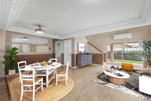 91-272 Kaieleele Pl, Ewa Beach, HI 96706 - dining space with an AC wall unit, a raised ceiling, baseboards, and wood finished floors