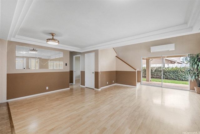 91-272 Kaieleele Pl, Ewa Beach, HI 96706 - unfurnished living room with a raised ceiling, a wall mounted air conditioner, and light wood-type flooring