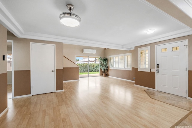 91-272 Kaieleele Pl, Ewa Beach, HI 96706 - foyer featuring a wall mounted AC, light wood-type flooring, baseboards, and a raised ceiling