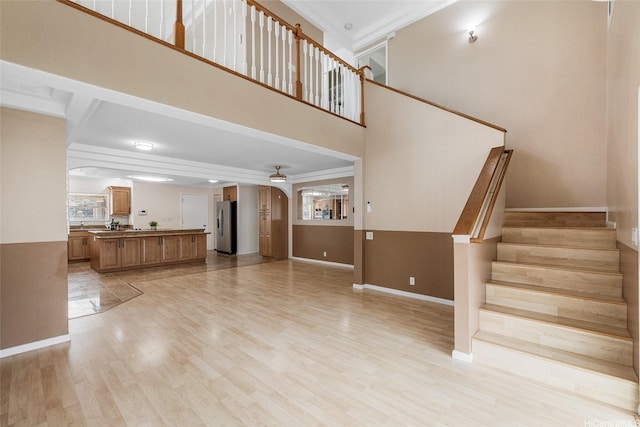 91-272 Kaieleele Pl, Ewa Beach, HI 96706 - unfurnished living room with baseboards, light wood-type flooring, stairs, ceiling fan, and a towering ceiling