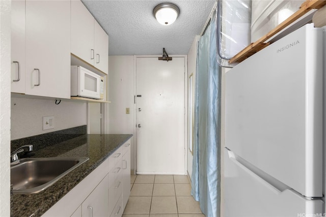 445 Seaside Ave Unit 3704, Honolulu, HI 96815 - kitchen featuring white appliances, a sink, white cabinets, a textured ceiling, and light tile patterned floors