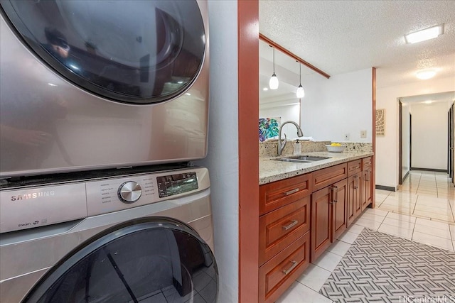 98-380 Koauka Loop Unit 304, Aiea, HI 96701 - washroom with stacked washer / dryer, a textured ceiling, and light tile patterned floors