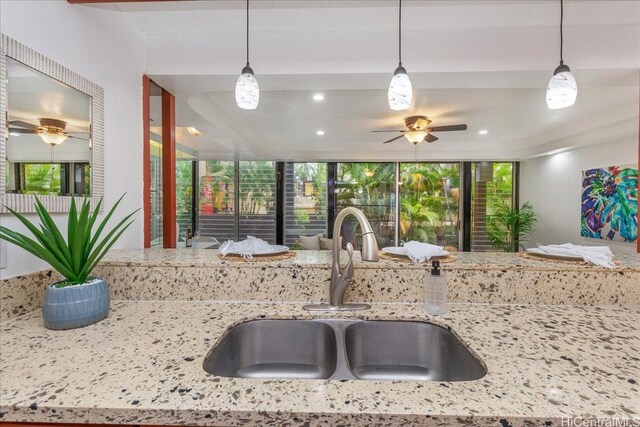 98-380 Koauka Loop Unit 304, Aiea, HI 96701 - kitchen featuring a sink, a ceiling fan, open floor plan, light stone counters, and decorative light fixtures
