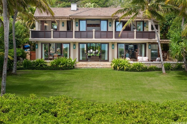 958 Mokulua Dr, Kailua, HI 96734 - back of house with a balcony, a yard, a tiled roof, and a chimney