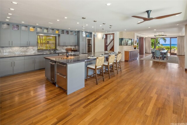 958 Mokulua Dr, Kailua, HI 96734 - kitchen featuring tasteful backsplash, a kitchen bar, a spacious island, recessed lighting, and a ceiling fan