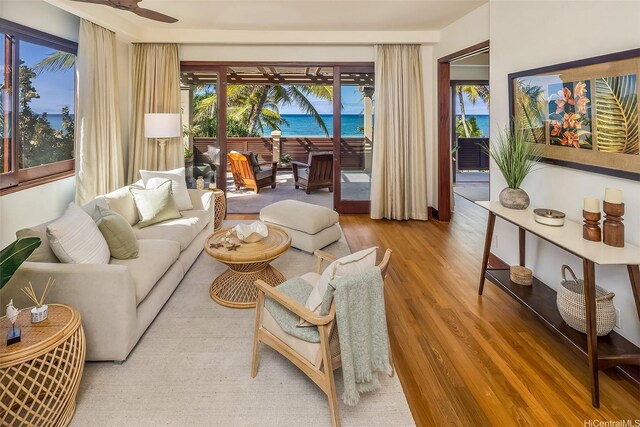 958 Mokulua Dr, Kailua, HI 96734 - living area featuring wood finished floors, a ceiling fan, and a water view