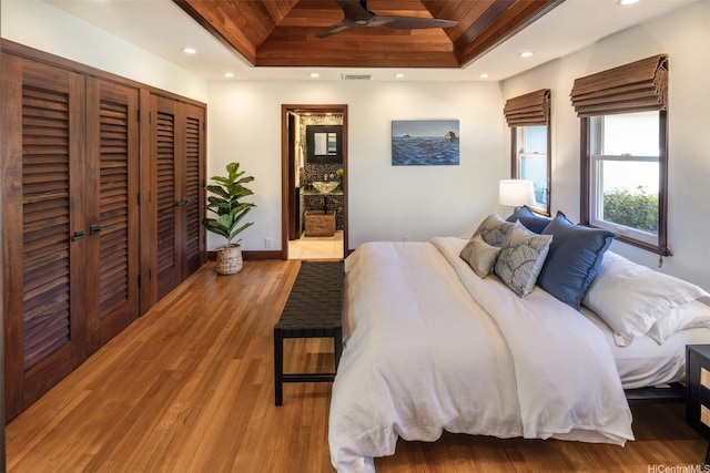 958 Mokulua Dr, Kailua, HI 96734 - bedroom featuring a tray ceiling, wood finished floors, recessed lighting, and baseboards