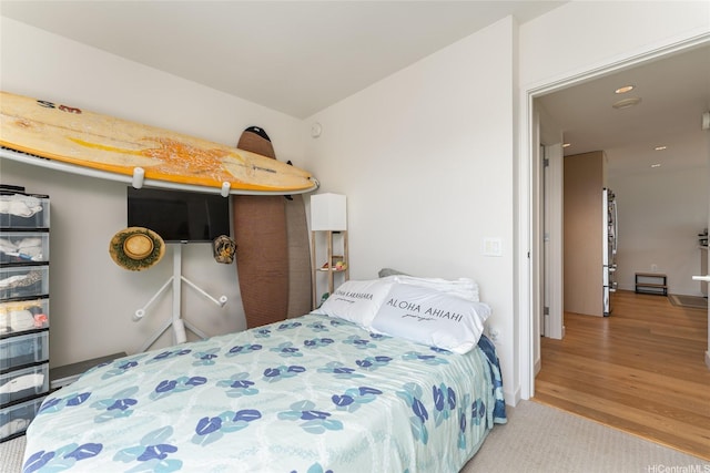 1001 Queen St Unit 3315, Honolulu, HI 96814 - bedroom featuring freestanding refrigerator, wood finished floors, and recessed lighting