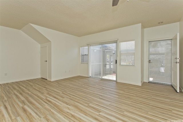 95-1030 Ainamakua Dr Unit 4, Mililani, HI 96789 - spare room with light wood-style floors, a textured ceiling, a ceiling fan, and baseboards