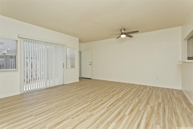 95-1030 Ainamakua Dr Unit 4, Mililani, HI 96789 - spare room featuring ceiling fan, light wood-style floors, baseboards, and a textured ceiling