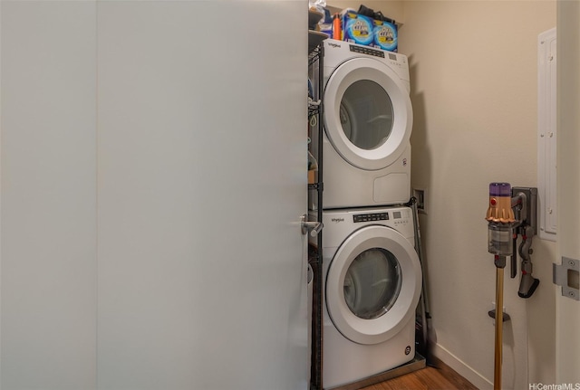 1391 Kapiolani Blvd Unit 4111, Honolulu, HI 96814 - laundry area featuring stacked washing machine and dryer, wood finished floors, and baseboards
