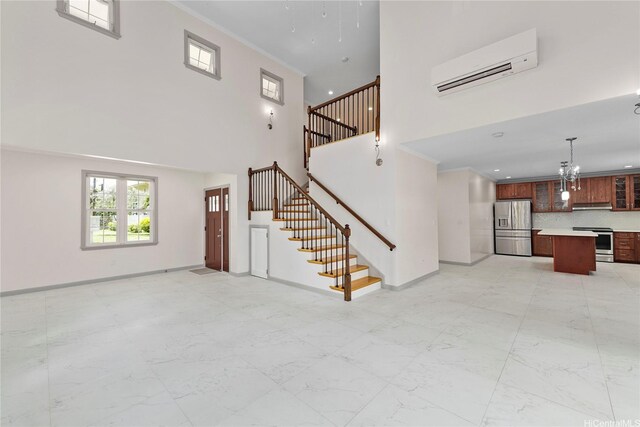 4162 Puu Panini Ave Unit A, Honolulu, HI 96816 - unfurnished living room with a wall unit AC, a high ceiling, stairway, baseboards, and light marble finish flooring