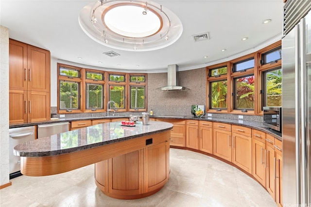 4498 Pahoa Ave, Honolulu, HI 96816 - kitchen featuring wall chimney exhaust hood, decorative backsplash, a center island, dark stone countertops, and stainless steel appliances