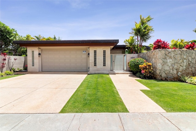 4498 Pahoa Ave, Honolulu, HI 96816 - view of front facade with a fenced front yard, an attached garage, concrete driveway, and a gate