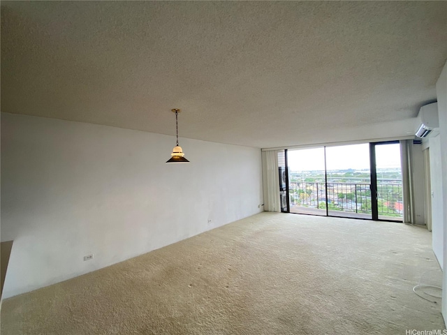 98-501 Koauka Loop Unit A1008, Aiea, HI 96701 - carpeted spare room featuring a wall mounted air conditioner, floor to ceiling windows, and a textured ceiling