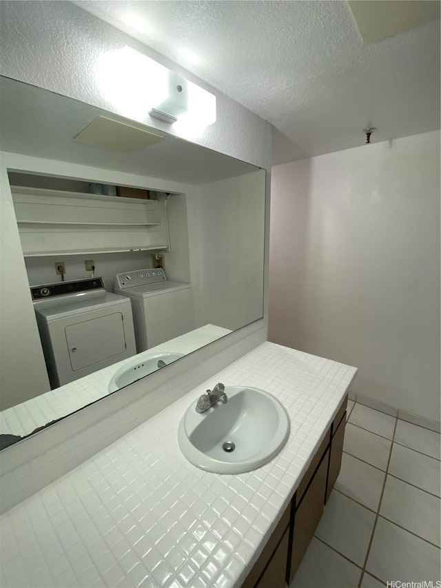 98-501 Koauka Loop Unit A1008, Aiea, HI 96701 - bathroom featuring independent washer and dryer, a textured ceiling, vanity, and tile patterned flooring