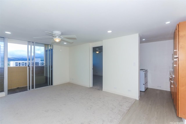 801 Ala Nioi Pl Unit 706, Honolulu, HI 96818 - empty room with ceiling fan, recessed lighting, baseboards, light wood-style floors, and light colored carpet