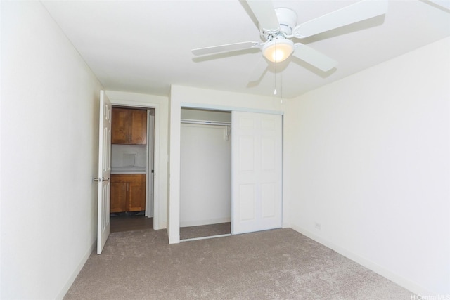 801 Ala Nioi Pl Unit 706, Honolulu, HI 96818 - unfurnished bedroom featuring carpet floors, a closet, a ceiling fan, and baseboards