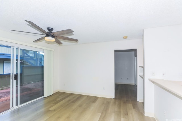 91-233 Hanapouli Cir Unit 29C, Ewa Beach, HI 96706 - unfurnished room featuring light wood finished floors, ceiling fan, a textured ceiling, and baseboards