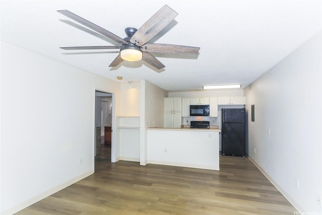 91-233 Hanapouli Cir Unit 29C, Ewa Beach, HI 96706 - kitchen featuring black appliances, a peninsula, wood finished floors, white cabinets, and light countertops