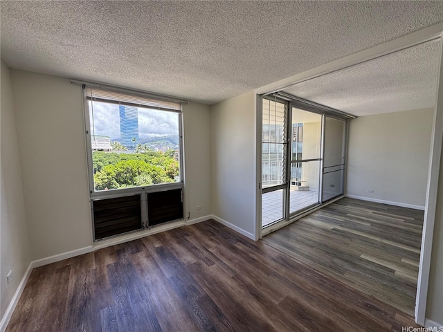 1717 Ala Wai Blvd Unit 501, Honolulu, HI 96815 - spare room featuring wood finished floors, a textured ceiling, and baseboards