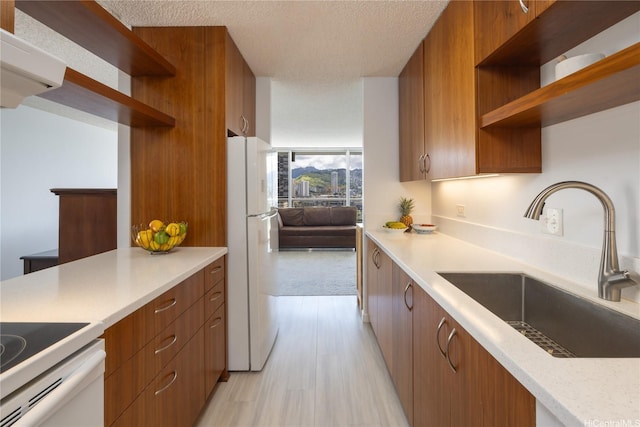 2233 Ala Wai Blvd Unit 10C, Honolulu, HI 96815 - kitchen with open shelves, freestanding refrigerator, light countertops, brown cabinets, and a textured ceiling