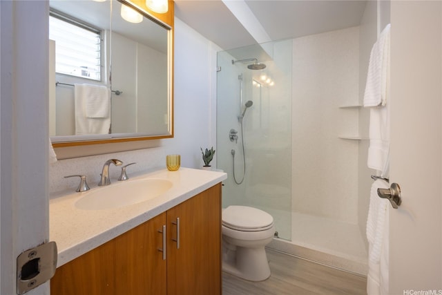 2233 Ala Wai Blvd Unit 10C, Honolulu, HI 96815 - bathroom featuring walk in shower, vanity, and wood finished floors