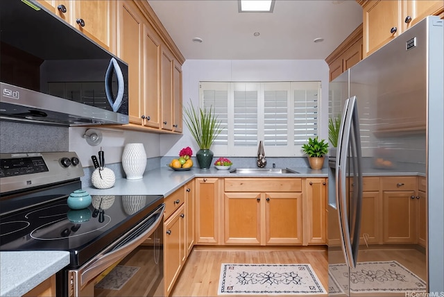 4280 Salt Lake Blvd Unit D23, Honolulu, HI 96818 - kitchen with appliances with stainless steel finishes, a sink, light wood-style flooring, and light countertops