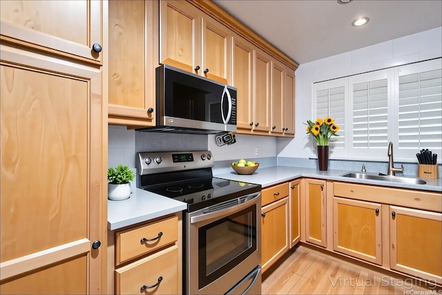 4280 Salt Lake Blvd Unit D23, Honolulu, HI 96818 - kitchen with appliances with stainless steel finishes, a sink, light countertops, recessed lighting, and light wood-style floors