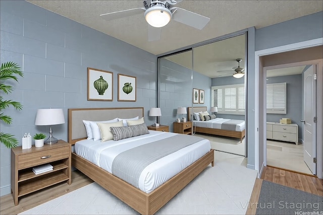 4280 Salt Lake Blvd Unit D23, Honolulu, HI 96818 - bedroom with a textured ceiling, a ceiling fan, a closet, and light wood finished floors