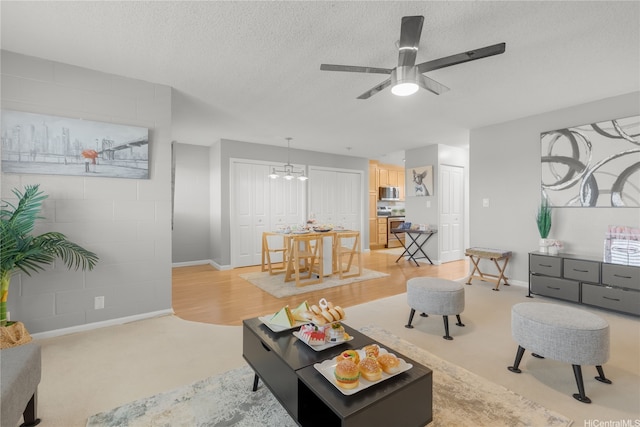 4280 Salt Lake Blvd Unit D23, Honolulu, HI 96818 - living room featuring baseboards, ceiling fan, a textured ceiling, a chandelier, and light carpet
