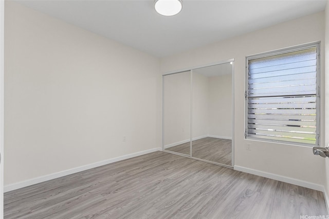 98-297 Ualo St Unit W1, Aiea, HI 96701 - unfurnished bedroom featuring light wood-type flooring, baseboards, and a closet