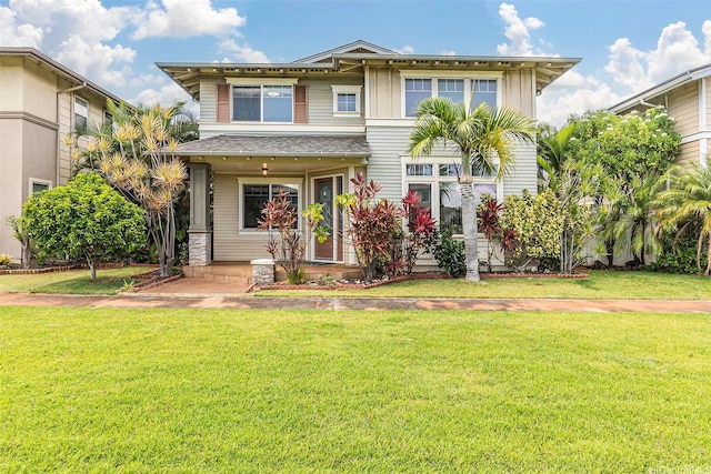 91-1019 Kai Uhu St, Ewa Beach, HI 96706 - view of front facade with a front lawn and board and batten siding