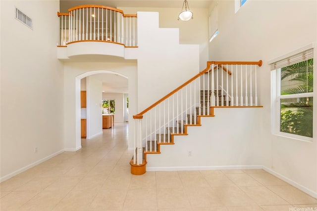 91-1019 Kai Uhu St, Ewa Beach, HI 96706 - staircase with a high ceiling, arched walkways, and tile patterned flooring