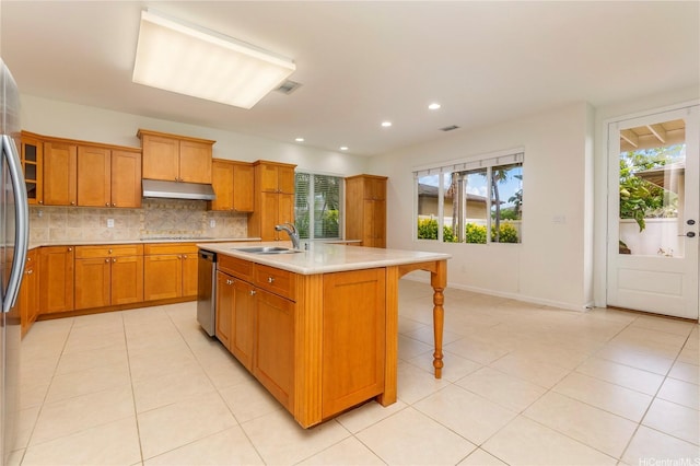 91-1019 Kai Uhu St, Ewa Beach, HI 96706 - kitchen featuring under cabinet range hood, stainless steel dishwasher, brown cabinetry, decorative backsplash, and light countertops