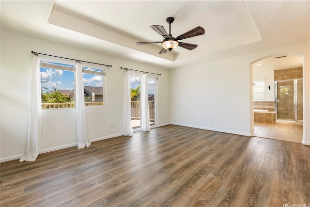 91-1019 Kai Uhu St, Ewa Beach, HI 96706 - spare room featuring a raised ceiling, arched walkways, a ceiling fan, and wood finished floors
