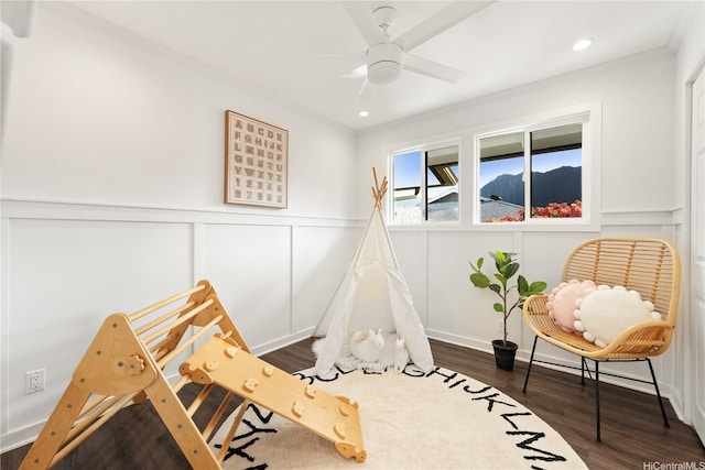 45-237 Popoki Pl, Kaneohe, HI 96744 - recreation room with crown molding, wainscoting, dark wood-style flooring, a ceiling fan, and a decorative wall