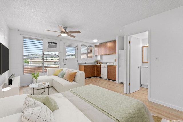 636 Nalanui St Unit 302, Honolulu, HI 96817 - living area with ceiling fan, light wood-style flooring, a textured ceiling, and baseboards