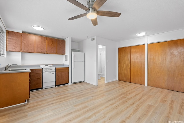 636 Nalanui St Unit 302, Honolulu, HI 96817 - kitchen featuring white appliances, a sink, brown cabinets, and light wood-style floors