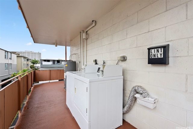 636 Nalanui St Unit 302, Honolulu, HI 96817 - laundry area featuring separate washer and dryer, concrete block wall, and carpet floors