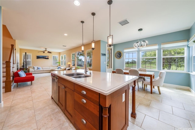 91-1099 Waikai St, Ewa Beach, HI 96706 - kitchen with brown cabinets, a sink, hanging light fixtures, a kitchen island with sink, and recessed lighting