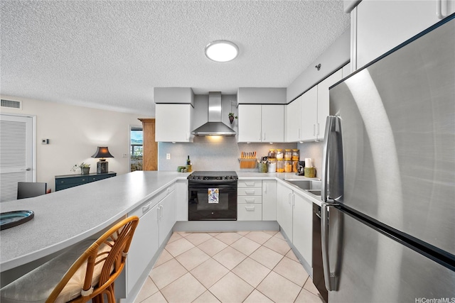 801 S King St Unit 1109, Honolulu, HI 96813 - kitchen featuring freestanding refrigerator, black electric range oven, wall chimney exhaust hood, light countertops, and light tile patterned floors