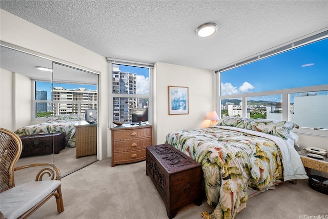 801 S King St Unit 1109, Honolulu, HI 96813 - bedroom featuring light colored carpet, a closet, a textured ceiling, and a wall of windows