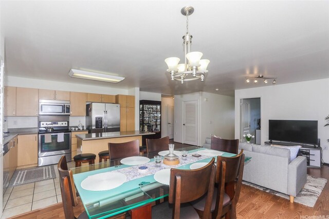 95-955 Ukuwai St Unit 1703, Mililani, HI 96789 - dining room featuring a chandelier and light wood-type flooring